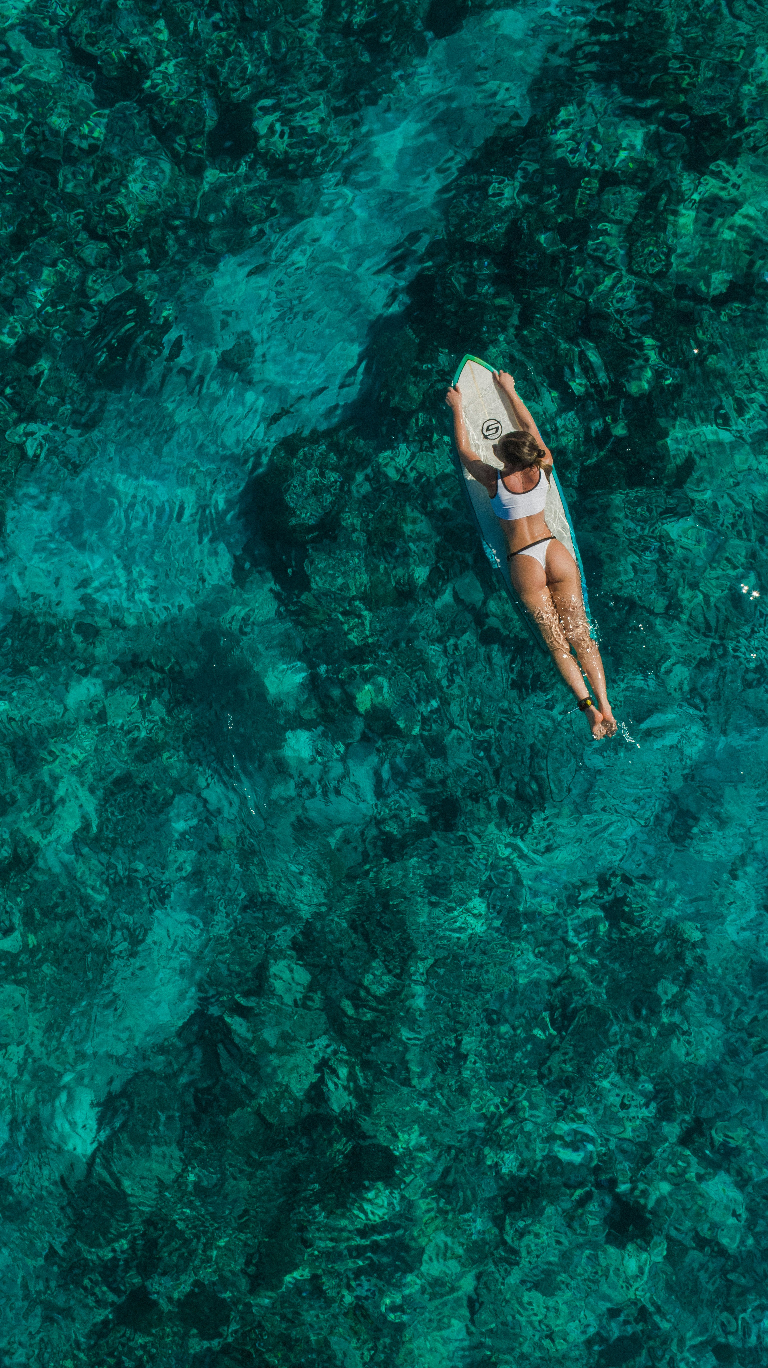 woman wearing white top and panty on body of water